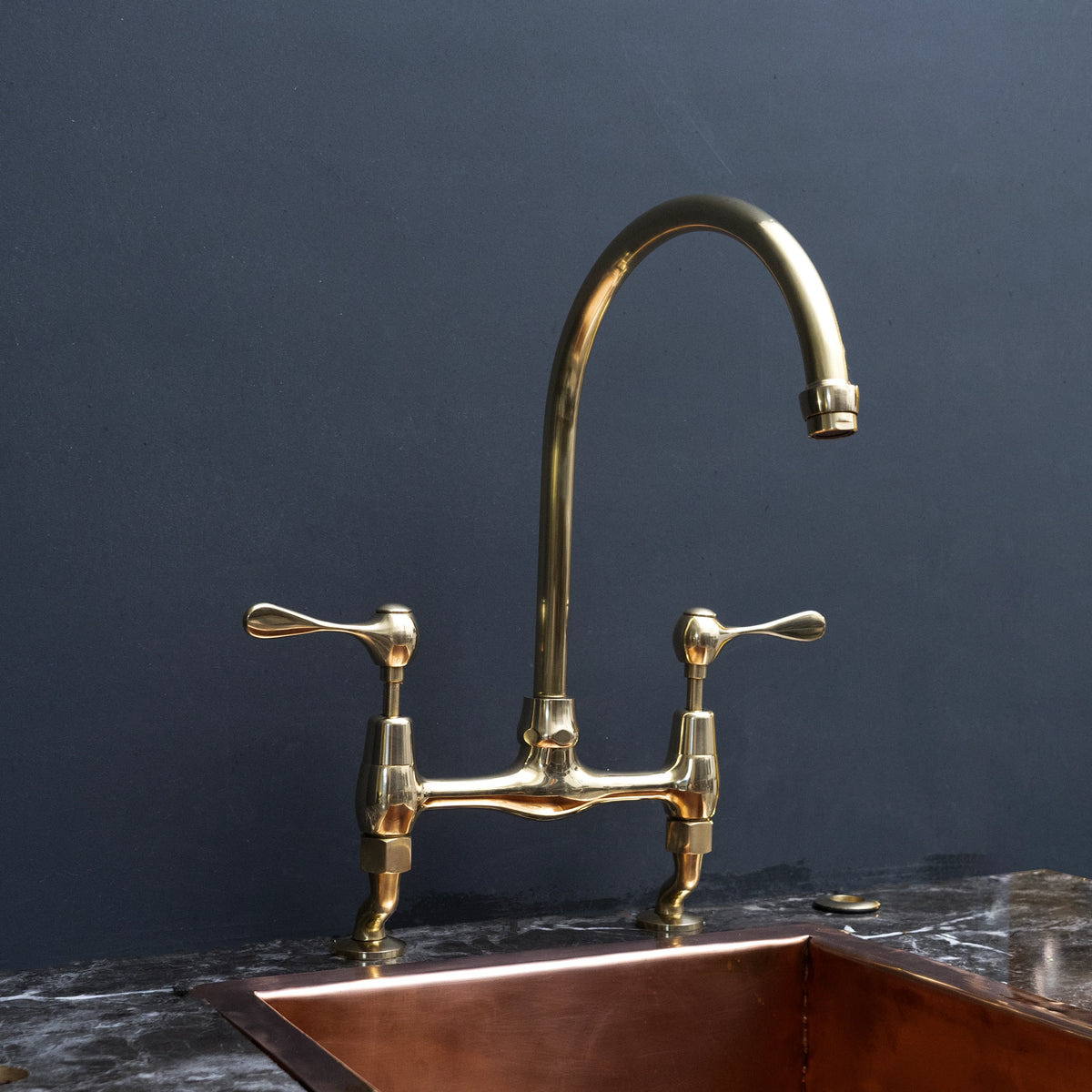 Unlacquered Brass Curved-Leg Bridge Kitchen Faucet – detail of curved legs