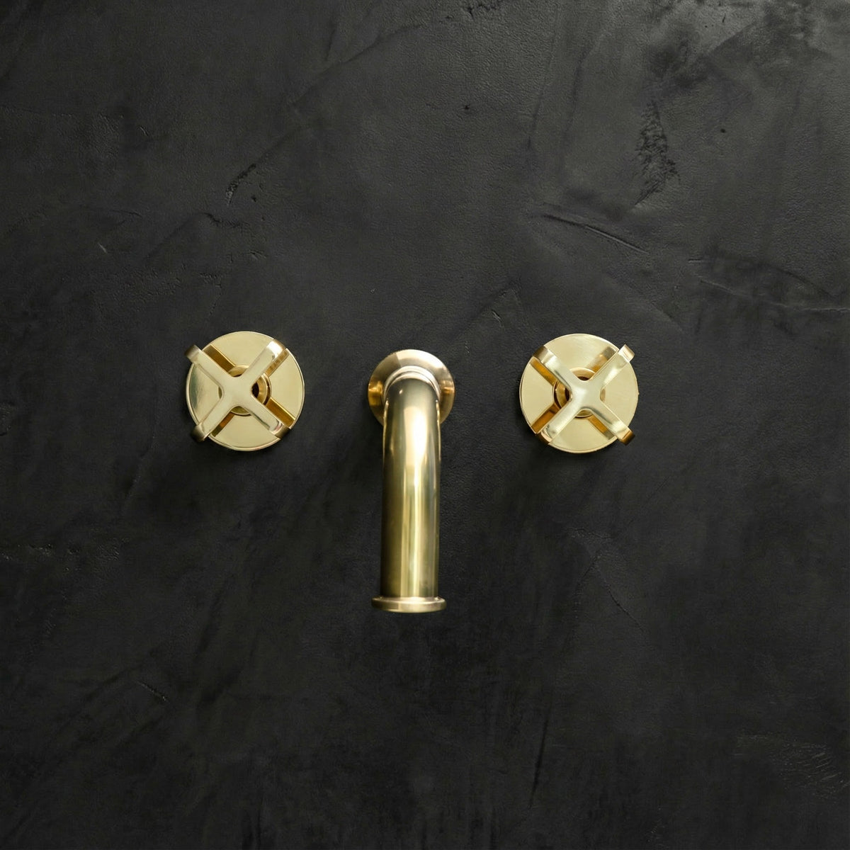 Unlacquered Brass Wall-Mount Faucet – Cross Handles – installed in bathroom setting